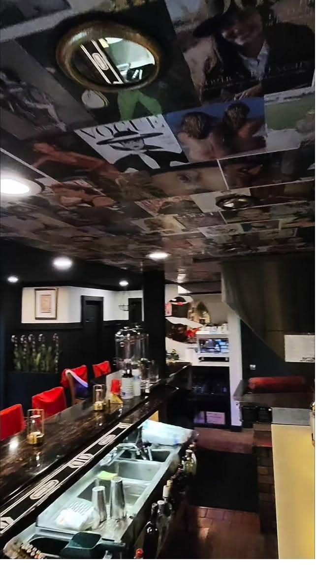 Vogue magazine covers collaged onto the ceiling of the bar